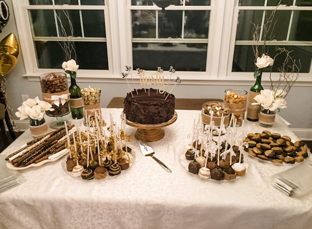 A dessert table featuring an assortment of chocolate dipped goodies at a bridal shower.