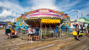Starship 3000 ride in motion at Jenkinson's Boardwalk. Visitors view ride.