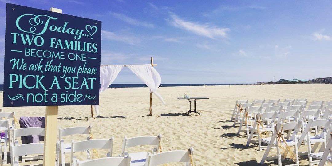 Chairs set up on the beach for a wedding ceremony.