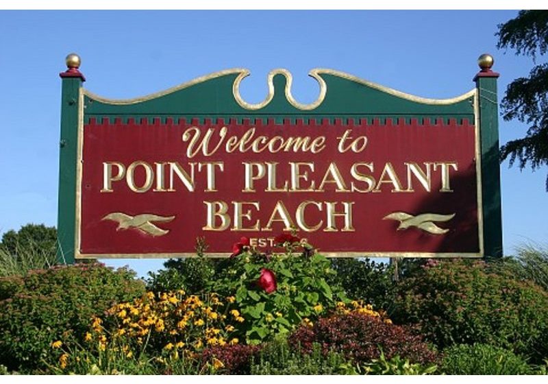 Red sign that says "Welcome to Point Pleasant Beach".